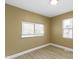 This bedroom features neutral walls, two windows, and wood-look flooring at 525 S Keystone Ave, Indianapolis, IN 46203