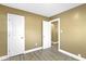 This bedroom features two closets, neutral walls and wood-look flooring at 525 S Keystone Ave, Indianapolis, IN 46203
