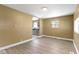 An empty living room with laminate wood floors and a view into the kitchen at 525 S Keystone Ave, Indianapolis, IN 46203
