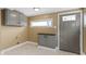Neutral mudroom features a window, built in cabinets, and access to the outside at 525 S Keystone Ave, Indianapolis, IN 46203