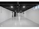 Large unfinished basement with painted floor, exposed ceiling, and stairs to upper level at 5802 Crittenden Ave, Indianapolis, IN 46220