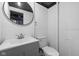 Basement bathroom featuring vanity, toilet, and mirror at 5802 Crittenden Ave, Indianapolis, IN 46220