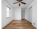 Bright bedroom features hardwood floors, a ceiling fan, and natural light from a window at 5802 Crittenden Ave, Indianapolis, IN 46220