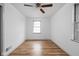 Well-lit bedroom features hardwood floors and natural light from two windows at 5802 Crittenden Ave, Indianapolis, IN 46220
