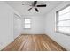Well-lit bedroom features hardwood floors, a ceiling fan, closet, and a window at 5802 Crittenden Ave, Indianapolis, IN 46220