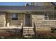 Home featuring stone exterior, flowers, and a beautiful entry way at 5802 Crittenden Ave, Indianapolis, IN 46220