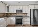 Updated kitchen features granite counters, stainless appliances, and light wood floors at 5802 Crittenden Ave, Indianapolis, IN 46220