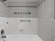 Clean shower featuring white and gray tiles with black trim and brushed nickel hardware at 5802 Crittenden Ave, Indianapolis, IN 46220