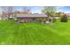 Aerial view of expansive backyard with a brick home and lush green lawn at 5925 Leisure Ln, Pittsboro, IN 46167