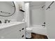 Bright bathroom features a white vanity with marble countertop and tiled shower over tub at 5925 Leisure Ln, Pittsboro, IN 46167