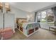 Comfortable bedroom with natural light, carpeted floors, and storage baskets under the bed at 5925 Leisure Ln, Pittsboro, IN 46167