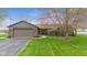 Charming home with a brick and siding exterior, well-manicured lawn, and paved driveway at 5925 Leisure Ln, Pittsboro, IN 46167