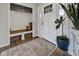Welcoming foyer with wood-look flooring, storage bench, and front door at 5925 Leisure Ln, Pittsboro, IN 46167