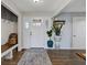 Bright foyer features wood floors, storage bench, and stylish decor at 5925 Leisure Ln, Pittsboro, IN 46167