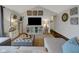 Comfortable living room features a TV, stylish ottoman, and carpeted floors at 5925 Leisure Ln, Pittsboro, IN 46167