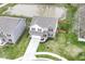 Aerial view of the residence showcases backyard pond, green spaces, and quiet neighborhood at 605 Tuscany Trl, Lapel, IN 46051
