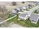 Aerial view of a neighborhood that shows the layout and the proximity to a small pond at 605 Tuscany Trl, Lapel, IN 46051
