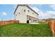 View of a fenced backyard with a well manicured lawn and a patio area for outdoor activities at 605 Tuscany Trl, Lapel, IN 46051