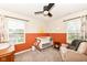 Cozy Bedroom featuring a modern ceiling fan, warm color accents, and a comfortable glider chair at 605 Tuscany Trl, Lapel, IN 46051