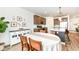 Dining room featuring a table with chairs, an open concept kitchen, and modern decor, perfect for gatherings at 605 Tuscany Trl, Lapel, IN 46051