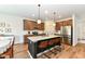 Well-lit kitchen with stainless steel appliances, a large island with seating, and ample counter space at 605 Tuscany Trl, Lapel, IN 46051