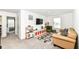 Bright living room featuring a large sofa, TV, play area, and a large window at 605 Tuscany Trl, Lapel, IN 46051