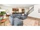 Open-concept living area boasts stainless appliances, island seating, and hardwood floors at 605 Tuscany Trl, Lapel, IN 46051