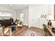Bright living room with tasteful decor, neutral walls, modern chair with natural light from window at 605 Tuscany Trl, Lapel, IN 46051