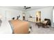 Large bedroom with neutral tones, comfortable furniture, and a view of the en-suite bath at 605 Tuscany Trl, Lapel, IN 46051
