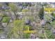 Aerial view of the home on a verdant lot with mature trees and a nearby shed at 6153 Evanston Ave, Indianapolis, IN 46220