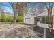 Backyard featuring garage, mature tree, and patio area perfect for outdoor enjoyment at 6153 Evanston Ave, Indianapolis, IN 46220