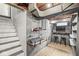 Finished basement with modern decor including shelves, lights, seating, and a workspace at 6153 Evanston Ave, Indianapolis, IN 46220