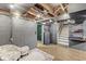 Spacious basement showcasing exposed ceiling and walls, with potential for various uses at 6153 Evanston Ave, Indianapolis, IN 46220