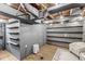 Exposed basement featuring painted walls, shelving, seating area, and updated flooring at 6153 Evanston Ave, Indianapolis, IN 46220