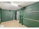 Unfinished basement with green walls, modern flooring and an open doorway at 6153 Evanston Ave, Indianapolis, IN 46220