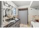 Elegant bathroom with a soaking tub, granite countertops, and decorative tile, blending luxury with functionality at 6153 Evanston Ave, Indianapolis, IN 46220