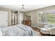 Cozy bedroom with hardwood floors, natural light, and sitting area near the window at 6153 Evanston Ave, Indianapolis, IN 46220