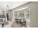 Cozy breakfast nook with a bay window, round table, and seating for two, illuminated by modern pendant lighting at 6153 Evanston Ave, Indianapolis, IN 46220