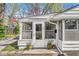 Close-up view of the inviting front porch, featuring potted plants and a screen door for breezy days at 6153 Evanston Ave, Indianapolis, IN 46220