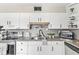 Bright kitchen featuring stainless steel appliances, white cabinets, and modern countertops at 6153 Evanston Ave, Indianapolis, IN 46220