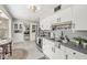 Well-lit kitchen with white cabinets, stainless steel appliances, and a tiled backsplash at 6153 Evanston Ave, Indianapolis, IN 46220