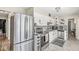 Bright kitchen featuring stainless steel appliances, white cabinets, and modern countertops at 6153 Evanston Ave, Indianapolis, IN 46220