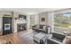 Stylish living room with a decorative fireplace, hardwood floors, large windows, and comfortable gray furniture at 6153 Evanston Ave, Indianapolis, IN 46220