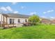Inviting backyard with a well-maintained lawn and wooden pergola offering a serene outdoor retreat at 6328 Dusty Laurel Dr, Whitestown, IN 46075