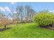 Lush green backyard with a charming garden and mature trees, perfect for outdoor activities and relaxation at 6328 Dusty Laurel Dr, Whitestown, IN 46075