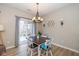 Bright dining area featuring modern chandelier lighting and sliding glass doors to the yard at 6328 Dusty Laurel Dr, Whitestown, IN 46075
