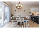 Cozy dining area featuring modern lighting, a dark wood table, and seating for six at 6328 Dusty Laurel Dr, Whitestown, IN 46075
