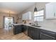 Well-lit kitchen with white countertops, dark cabinets, and stainless steel appliances at 6328 Dusty Laurel Dr, Whitestown, IN 46075