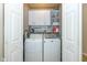 Functional laundry room with overhead cabinets, washer, and dryer, offering ample storage and convenience at 6328 Dusty Laurel Dr, Whitestown, IN 46075