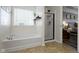 Bright bathroom featuring a soaking tub, glass-enclosed shower, and natural light at 6586 W Winding Bnd, McCordsville, IN 46055